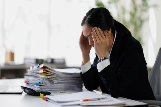 Businesswoman experiencing migraine from overwhelming office work burnout
