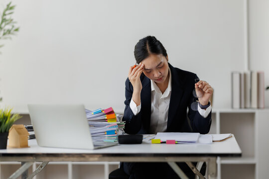 Stressed business woman feeling headache in office