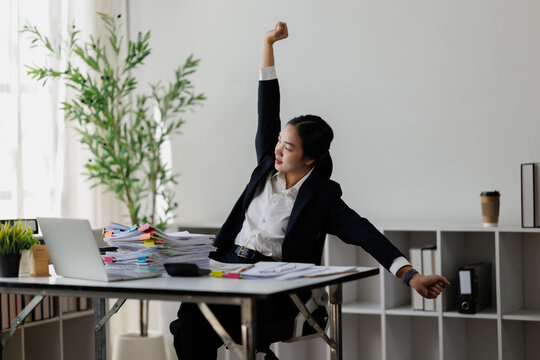 Businesswoman stretching during long working hour in office
