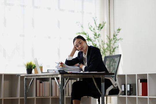 Stressed businesswoman suffering burnout at office desk
