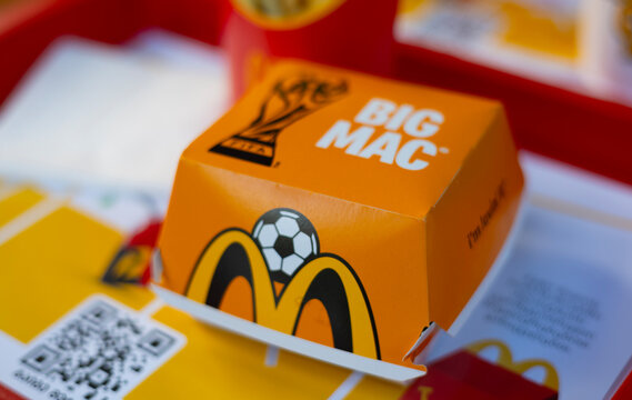 Tbilisi, Georgia - July 4, 2026: Defocused photo. Paper box with Big Mac burger, Golden arches, Fifa world Cup logo football ball on fast food cafe McDonald's table. Lunch, eat, sport, dinner, meal
