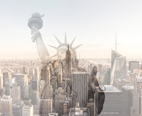 Double exposure of Manhattan skyline in new york city with statue of liberty silhouette © Maria