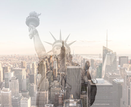Double exposure of Manhattan skyline in new york city with statue of liberty silhouette