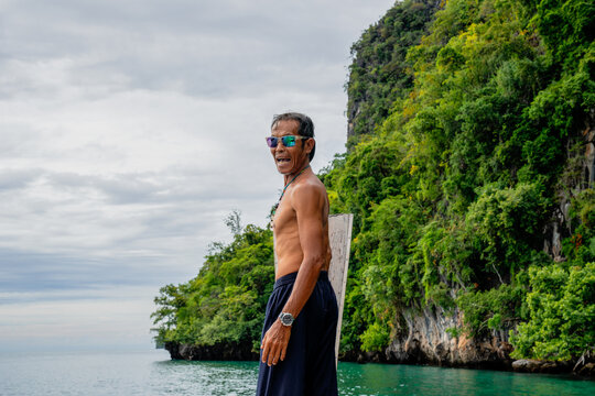 Older man on boat enjoying tropical sea vacation