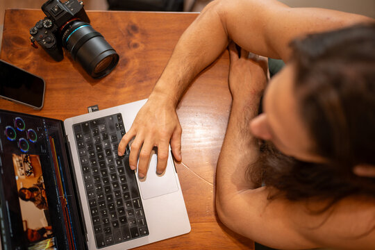 Creative professional editing video on laptop at home