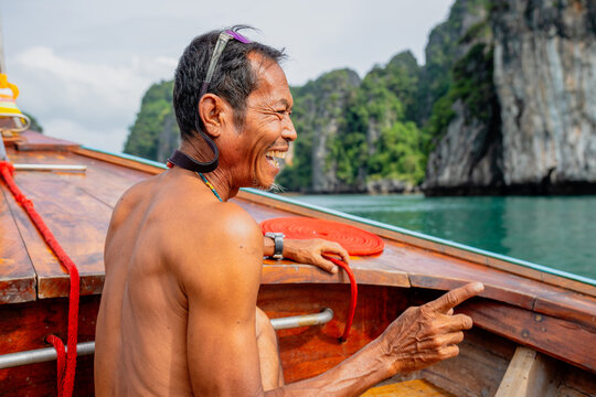 Happy elderly man laughing discovering island travel