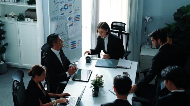 Business people sitting at seat and prepare for meeting at whiteboard with colorful sticky notes and mind map. Professional diverse group talking about marketing plan at meeting room. Directorate.