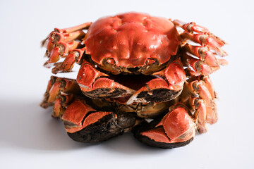 Stack of cooked red crabs on white background © Wang Dan