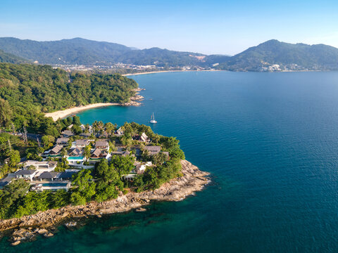 Aerial top view of Surin beach and Kamala Beach. Turquoise waves reach the Andaman sea coastline on a sunny day. Travel attractions for summer vacation in Phuket, Thailand.