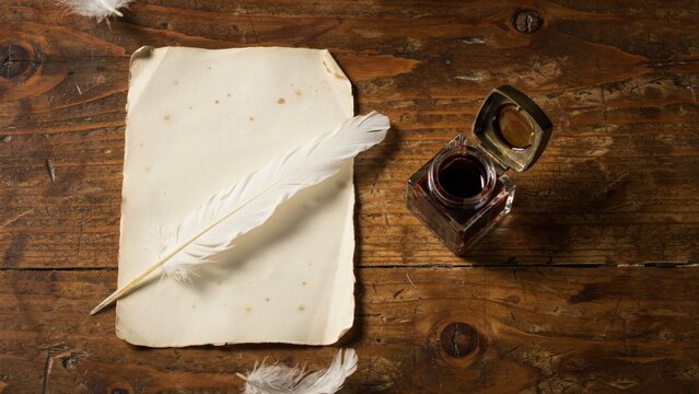 White quill pen resting on aged parchment with dark inkwell
