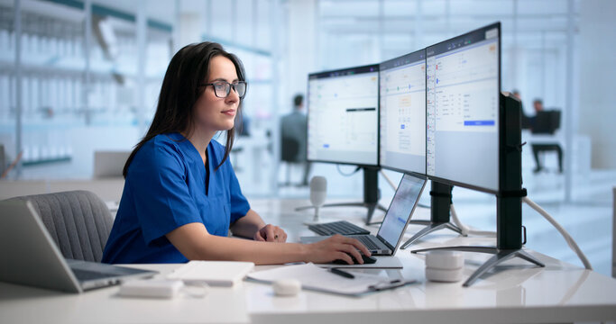 Woman Uses Laptop Reviewing Medical Billing Codes