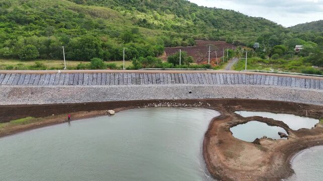 The rocks of various sizes lining the embankment to protect the dam and road would be damaged during the rainy season.