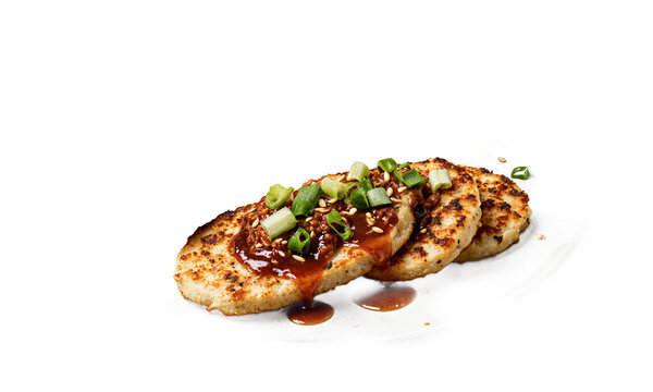 Bindaetteok savory pancake Korean food three mung bean pancakes drizzled with sauce and scallions on a transparent background