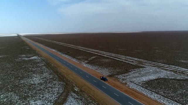 Stunning drone capture of vast desert salt marsh landscape with layered earth tones.