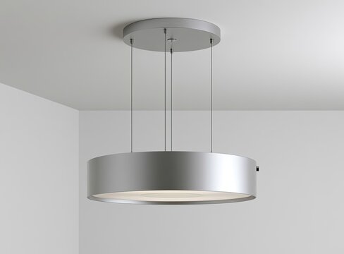 Modern silver cylindrical pendant light fixture with diffused glow, suspended from ceiling