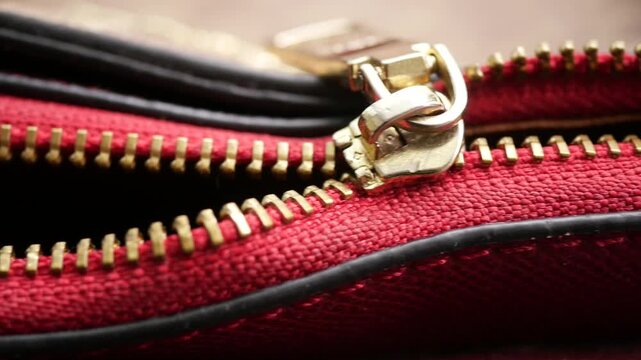 Close look at a broken zipper of a woman purse