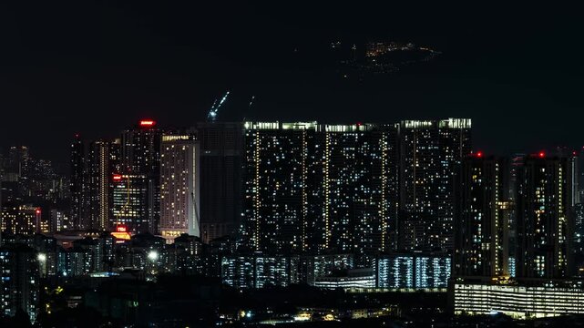 Tower Crane in the sky doing construction at night time lapse, Genting Highlands in background