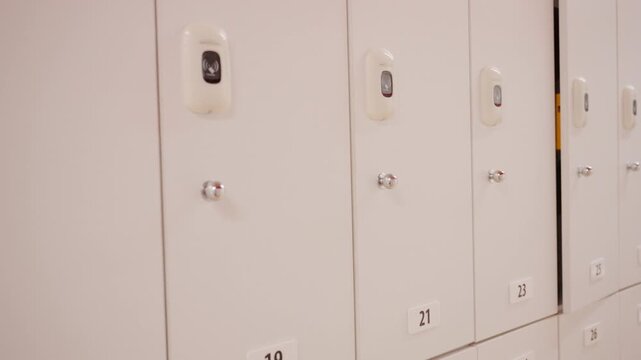 Person closing locker with electronic key fob
