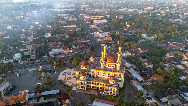 Kecamatan Klaten Utara, Jawa Tengah, Indonesia - 02 July 2026: Aerial view of Al Aqsha Great Mosque Klaten with its domes surrounded by urban rooftops, trees, and roads.