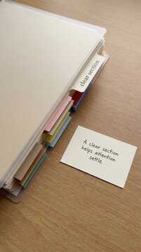 Organization Aids Low Attention Span: Labeled Document Tabs and Informative Note on Wooden Desk