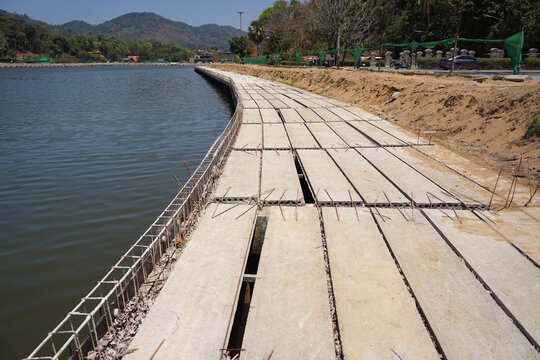 Building process city levee. Exposed foundation rebar grid at site, standing formwork and concrete footings