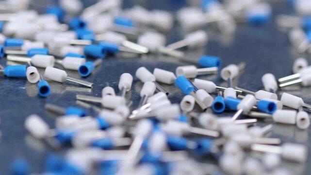 Metal tips with a plastic base for mounting on stranded copper wires. Close-up. Soft focus. Macro.
