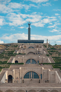 Symmetric view of Yerevan Cascade complex with monument under cloudy sky with copy space