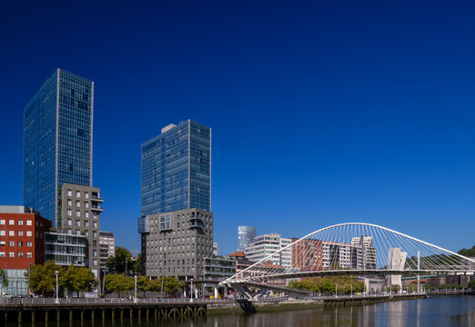 Zubizuri pedestrian bridge connecting river banks with modern architecture in bilbao
