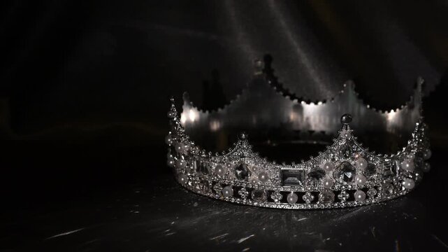Refined golden crown with gemstones on dark textured background, symbol of luxury and high status. Subtle light reflections create a sense of sophistication, exclusivity and elevated status. 