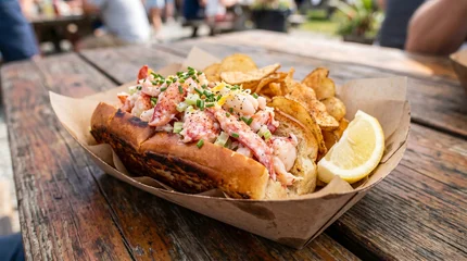 Authentic New England Lobster Roll with Potato Chips and Lemon Served in Paper Tray © olindana