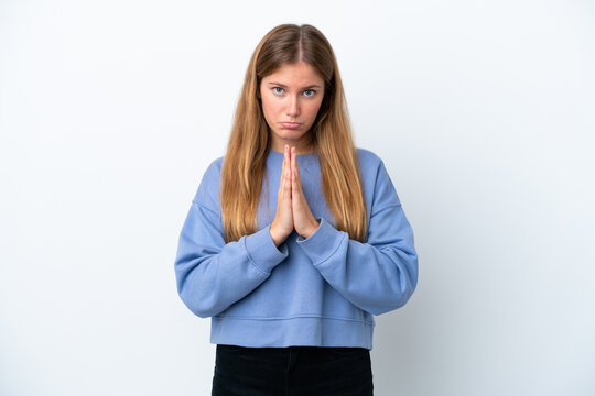 Young blonde woman isolated on white background keeps palm together. Person asks for something