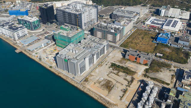 Hong Kong, Hong Kong - 14 February 2026: Aerial view of the Tseung Kwan O industrial estate with modern data centers, warehouses, and construction sites along the waterfront.