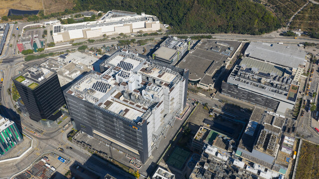 Hong Kong, Hong Kong - 14 February 2026: Aerial view of a modern data center complex with large industrial buildings, rooftop HVAC units, solar panels, and surrounding urban infrastructure.