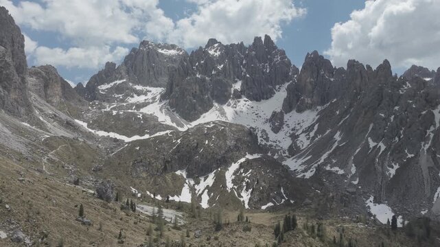 Dramatic Snow-Capped Jagged Mountain Peaks Under Blue Sky