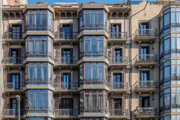 Obraz premium Traditional Residential Building Facade with Balconies in Barcelona, Classic Eixample District Architecture