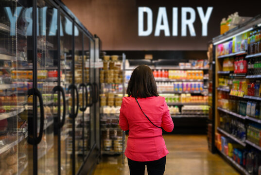 Woman shopping at Dairy section of a grocery shop. California. USA.