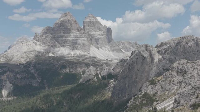 Dramatic Snow-Capped Jagged Mountain Peaks Under Blue Sky