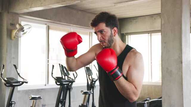 Man Throwing Boxing Punch During Gym Workout