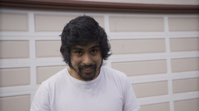 Young Man Smiling And Looking at Camera In Slow Motion Close-Up