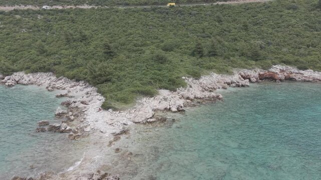 Small Rocky Island with Pine Trees in Turquoise Sea