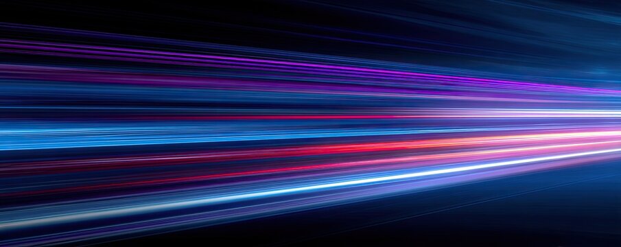Streaks of vibrant light in blues, purples, and reds blur into motion