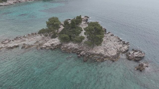 Small Rocky Island with Pine Trees in Turquoise Sea