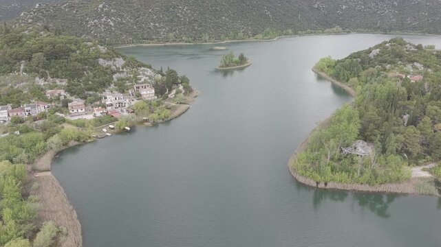 Aerial View of Serene Mountain Lake Surrounded by Green Hills