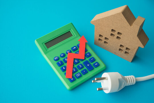House, electrical plug and calculator with growth red graph on blue background. Electricity prices increase, energy crisis in war, home financial management and planning, expense control concept.