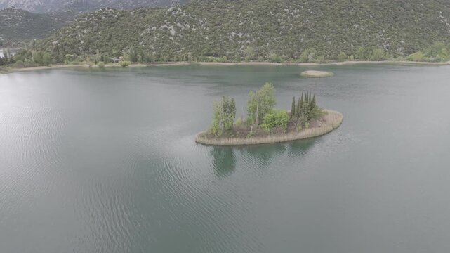 Aerial View of Serene Mountain Lake Surrounded by Green Hills