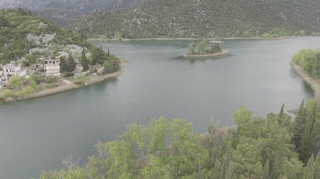 Aerial View of Serene Mountain Lake Surrounded by Green Hills
