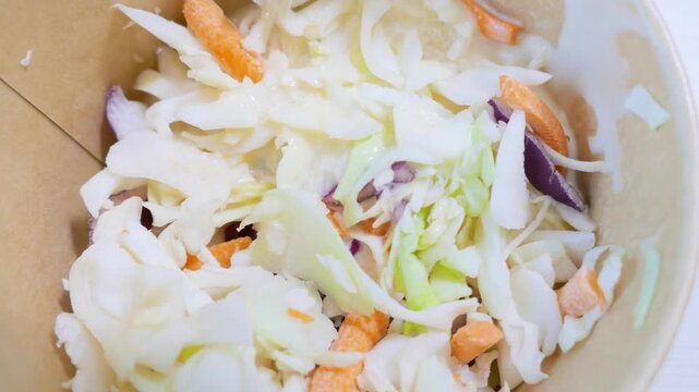Macro texture of raw shredded cabbage and carrot slaw salad
