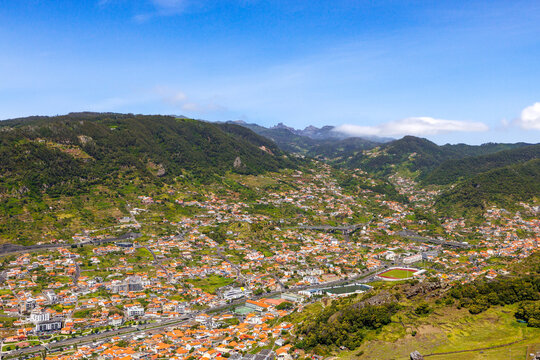 Panoramic view of Machico town with traditional red roofs from Pico do Facho, Madeira, Portugal