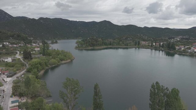 Aerial View of Serene Mountain Lake Surrounded by Green Hills