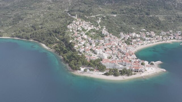 Aerial View of Coastal Village with Church Tower and Mountain Bay